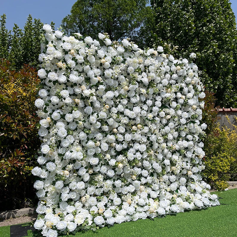 Large floral wall made of white flowers in a garden setting