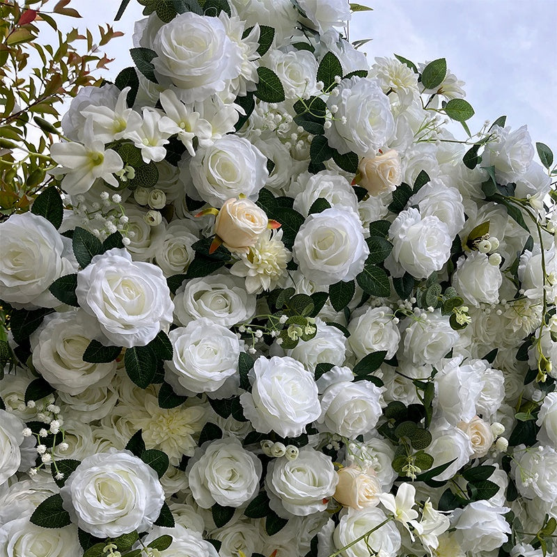 Artificial white and green floral arrangement against a clear sky.